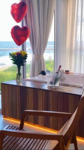 a room with a table with hearts hanging from a window at Casa Cancun Hotel Boutique & Eventos in Penha +99 photos