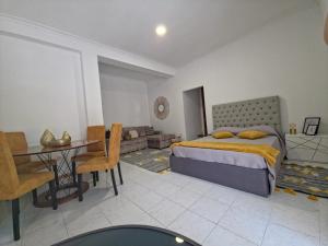 a bedroom with a bed and a dining room at Garça-Real 1 in Vale de Madeiros +5 photos