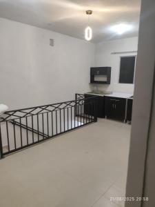 a kitchen with white walls and a staircase in a room at casa confortabla y relajante con alberca y laguna in Monterrey