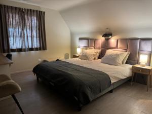 ein Schlafzimmer mit einem großen Bett und zwei Lampen darauf in der Unterkunft Hotel De Villa in Zelzate