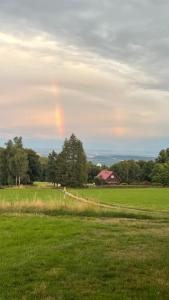 a rainbow in the middle of a field at Sedlinka Klíny in Klíny +4 photos