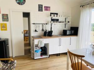 a kitchen with white cabinets and a table at Sedlinka Klíny in Klíny