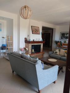 a living room with a couch and a fireplace at Stamoulis Garden House in Katigiorgis