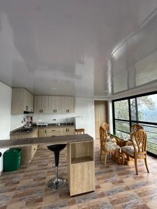 a kitchen with a counter and a table and chairs at Casa Lemora in Vergara