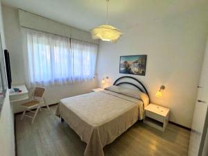 a bedroom with a large bed and a window at Villa Lilly in Grado