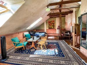 a living room with a table and chairs on a rug at Apartmány Za branou in Kutná Hora