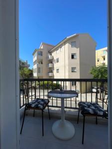 a balcony with a table and chairs and a building at Domus de janas 2 in Alghero