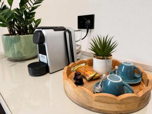 a kitchen counter with a tray of tea set at Ghosen Al Zaitoon chalet in Sayq