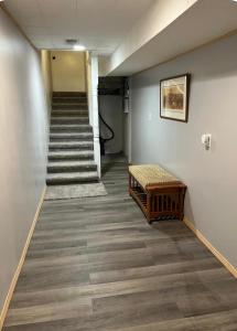 a hallway with stairs and a bench in a building at Oasis Studio in Cambridge