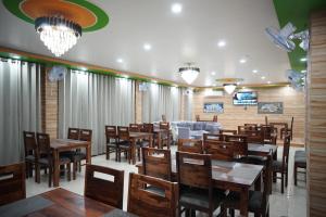 a dining room with wooden tables and chairs at Hotel Arijika View in Kullu Manali
