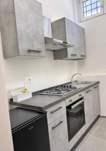 a kitchen with stainless steel appliances and a stove at Atmosfere 19 in Sant'Egidio del Monte Albino