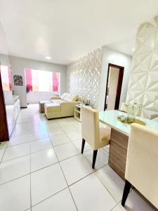 a large living room with a table and chairs at Apartamento Park Vinhais in São Luís