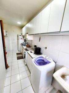 a kitchen with a toilet with a purple bowl on it at Apartamento Park Vinhais in São Luís +2 photos