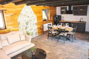 a living room with a table and a kitchen at Senjska Villa in Josipdol