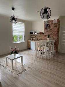 a kitchen and living room with a table and chairs at Parka ielas apartamenti in Limbaži