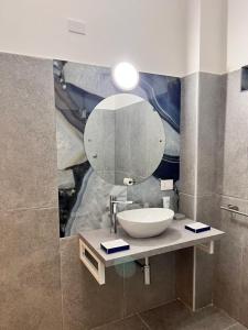 a bathroom with a sink and a mirror at Atmosfere 19 in Sant'Egidio del Monte Albino +18 photos