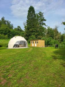 a large tent in the middle of a field at Pen-Y-Fan Glamping - Luxury Geodomes in Sennybridge