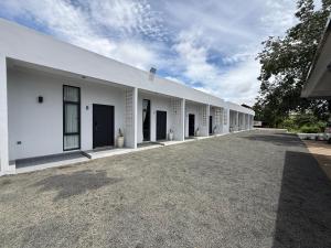 a white building with a long row of windows at Family Motel in Bahal