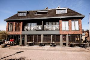 a building with tables and chairs in front of it at Hotel La Boutique in Nijmegen