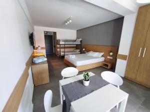 a bedroom with a bed and a table and chairs at ISALOS GERAKiNi in Yerakiní