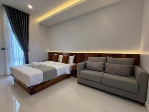 a bedroom with a bed and a couch at Family Motel in Bahal