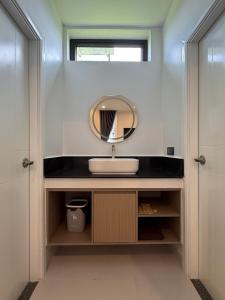a bathroom with a sink and a mirror at Family Motel in Bahal
