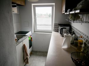 a kitchen with a counter top with a window at Dom jednorodzinny NOWA in Dęblin