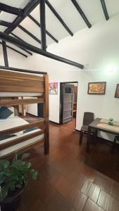 a room with a bed and a table and a dining room at Tour La Matrona in Villa de Leyva +2 photos