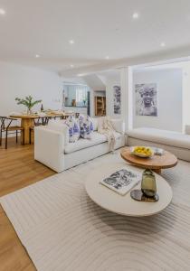 a living room with a white couch and a table at Mountain views oasis in Franschhoek