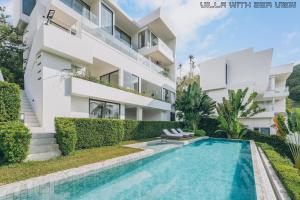 an apartment building with a swimming pool in front of it at AAA villa in Ban Bang Po