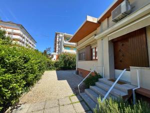 a house with stairs leading up to a building at Villa Lilly in Grado +6 photos