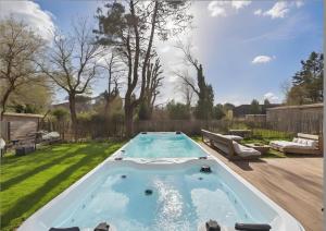 a swimming pool in the middle of a yard at Villa Émeraude Spa in Le Porge