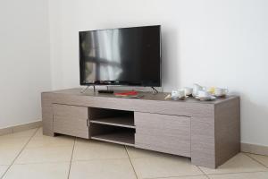 a entertainment center with a flat screen tv on it at Bono Vacanze Casa Bono in Sciacca