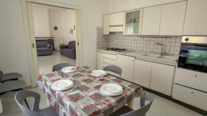 a kitchen with a table with plates on it at Casa Gala in Mamoiada