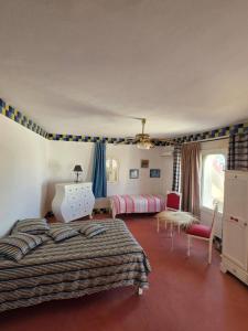 a bedroom with two beds and a table and chairs at Nanou in Zarzis +18 photos