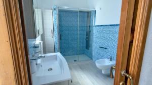 a bathroom with a shower and a sink and a toilet at Casa Gala in Mamoiada +16 photos