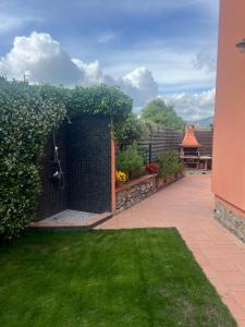a garden with a brick wall and green grass at Casa Alma in Sestri Levante