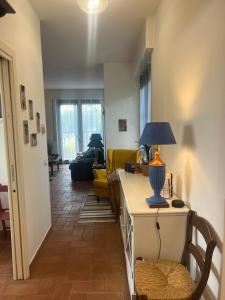 a living room with a table with a lamp on it at Casa Alma in Sestri Levante +14 photos