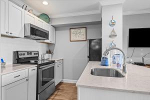 a kitchen with a sink and a stove at 111 Water Street Inn in Boyne City