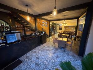 a restaurant with a bar with tables and chairs at Hotel Posada de Piedra in Orizaba +76 photos