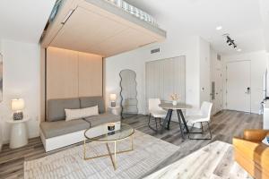 a living room with a couch and a table at Modern Hollywood Studio, Pool Parking Gym in Los Angeles