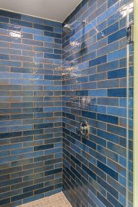 a blue tiled shower with a blue tile wall at Modern Hollywood Studio, Pool Parking Gym in Los Angeles +12 photos