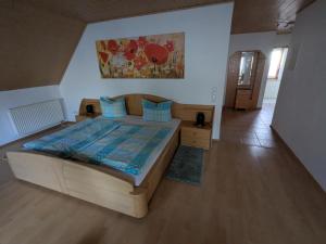 a bedroom with a large bed with blue pillows at FeWo am Heimlisberg in Friesenheim