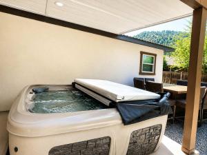 a jacuzzi tub in a patio with a table at Quiet Escape in Ruidoso +26 photos
