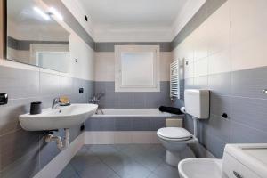 a bathroom with a sink and a toilet and a tub at Aphrodite's Garden in Gera Lario +18 photos