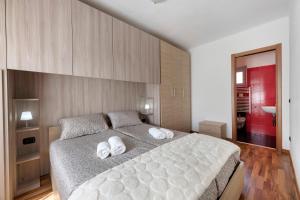 a bedroom with a large bed with two white towels at Aphrodite's Garden in Gera Lario