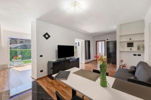 a living room with a couch and a table at Aphrodite's Garden in Gera Lario