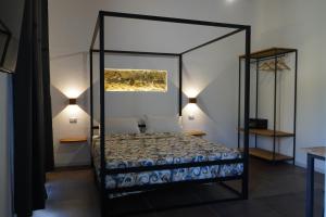 a bedroom with a canopy bed and two lamps at L'antica Dimora Fronte Mare in Finale