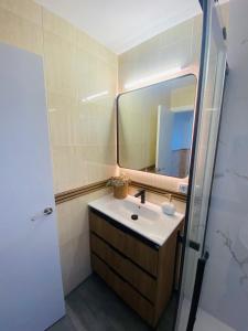 a bathroom with a sink and a mirror at Casa Cañailla in El Rompido +6 photos