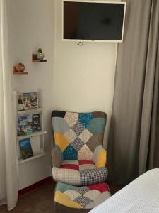a room with a chair and a television on a wall at Casa Porto Vecchio in Peschiera del Garda +42 photos